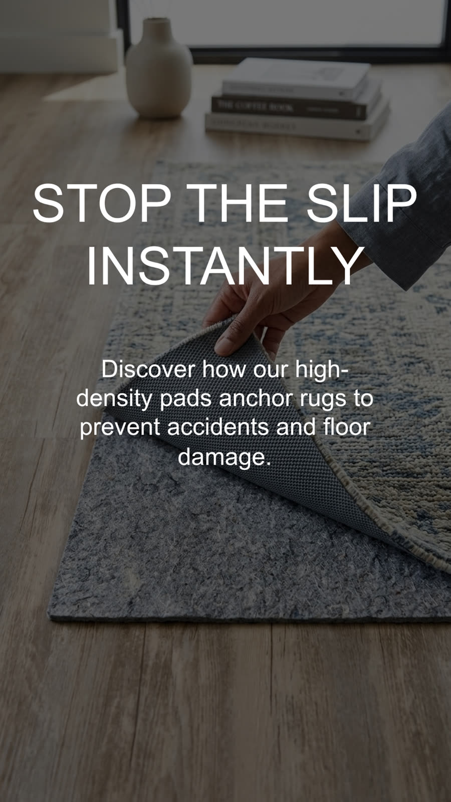 Hand turning back a rug to show the felt rug pad underneath that keeps the rug from slipping
